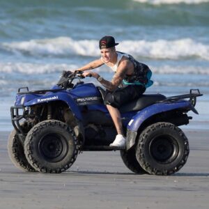 Justin Bieber take to a Panamanian beach on a ATV watched by Chantel Jeffries